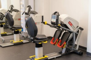 Fiziskās terapijas aprīkojums Rīgas 1. slimnīcā, iekārtas SCI FIT. Redzami divi trenažieri.
